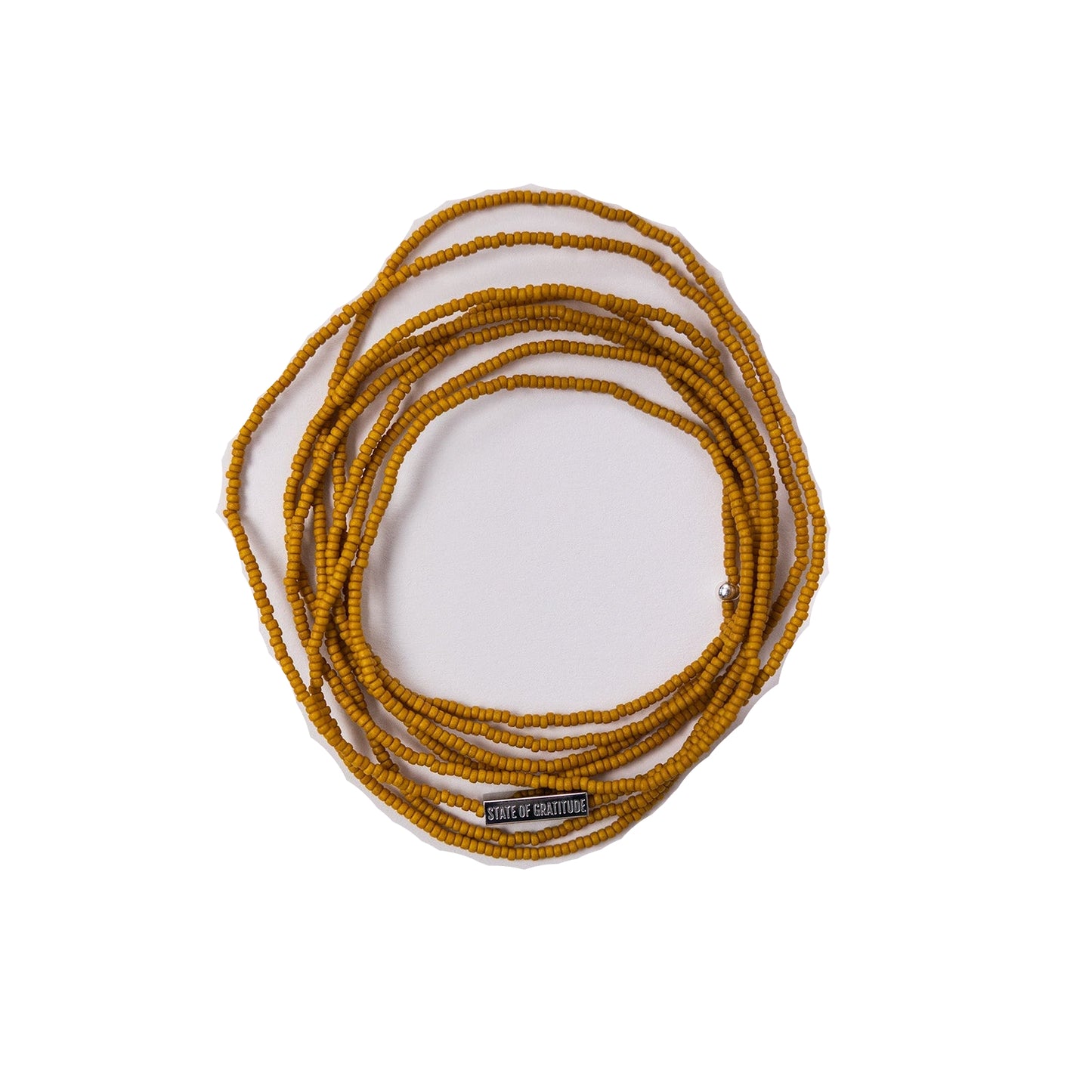 Coiled yellow bracelet on a white background