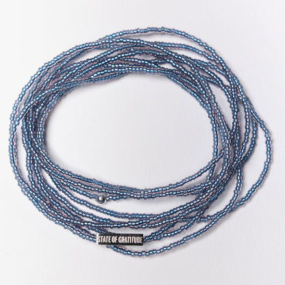Blue beaded necklace on a white background