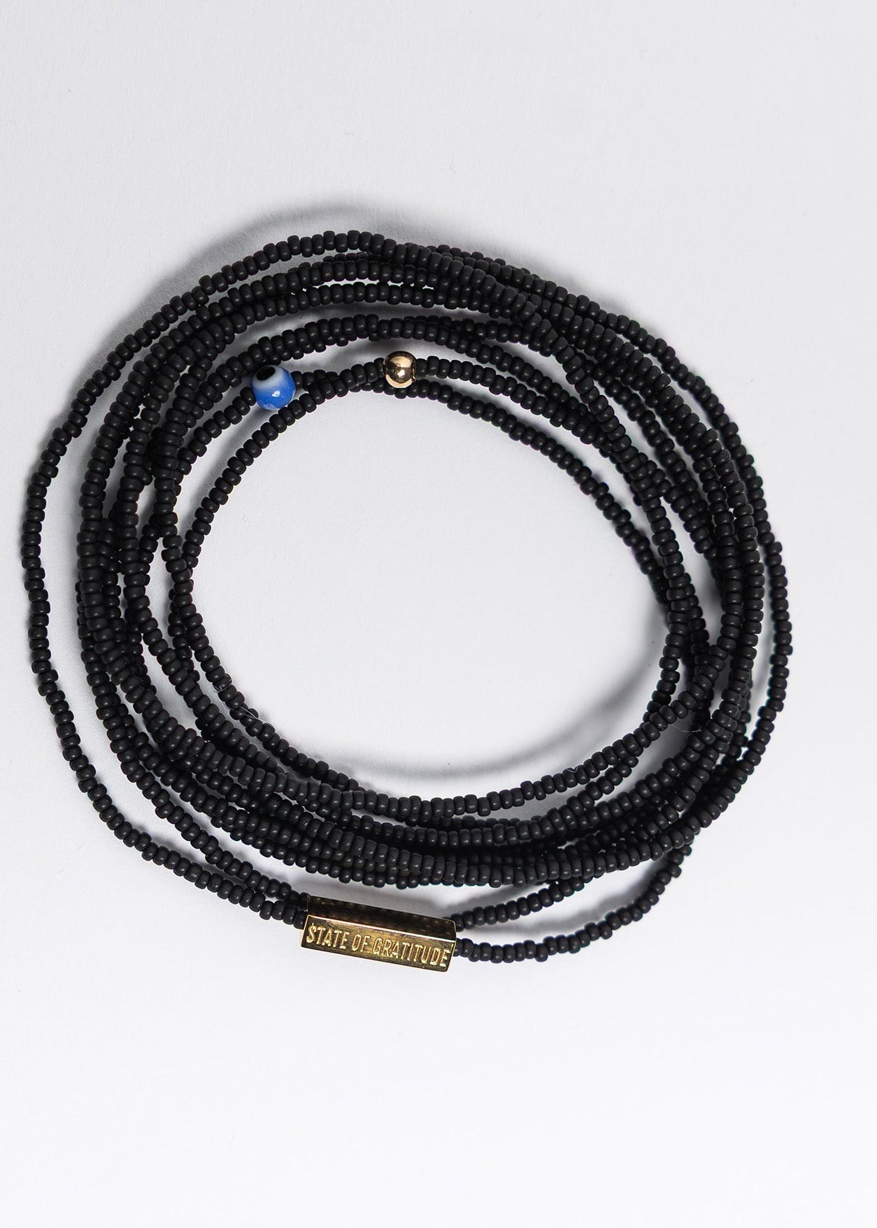 Black beaded necklace on a white background