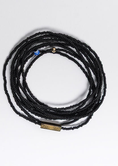 Black beaded necklace on a white background