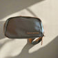 sage green belt bag with 'State of Gratitude' branding on a beige background