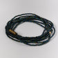 Multistrand beaded bracelet with a brand tag on a light gray background