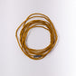 Coiled yellow bracelet on a white background