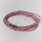 mauve beaded bracelet on a light gray background