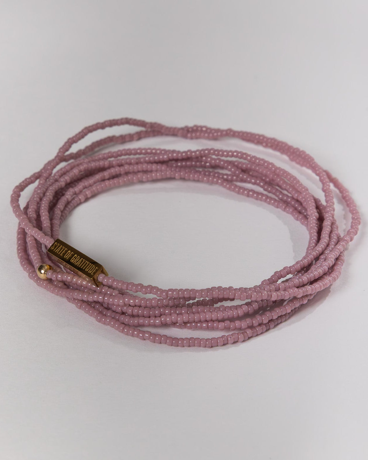mauve beaded bracelet on a white background