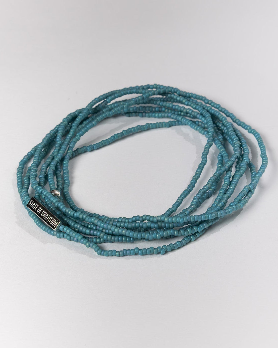 nile blue beaded necklace on a white background