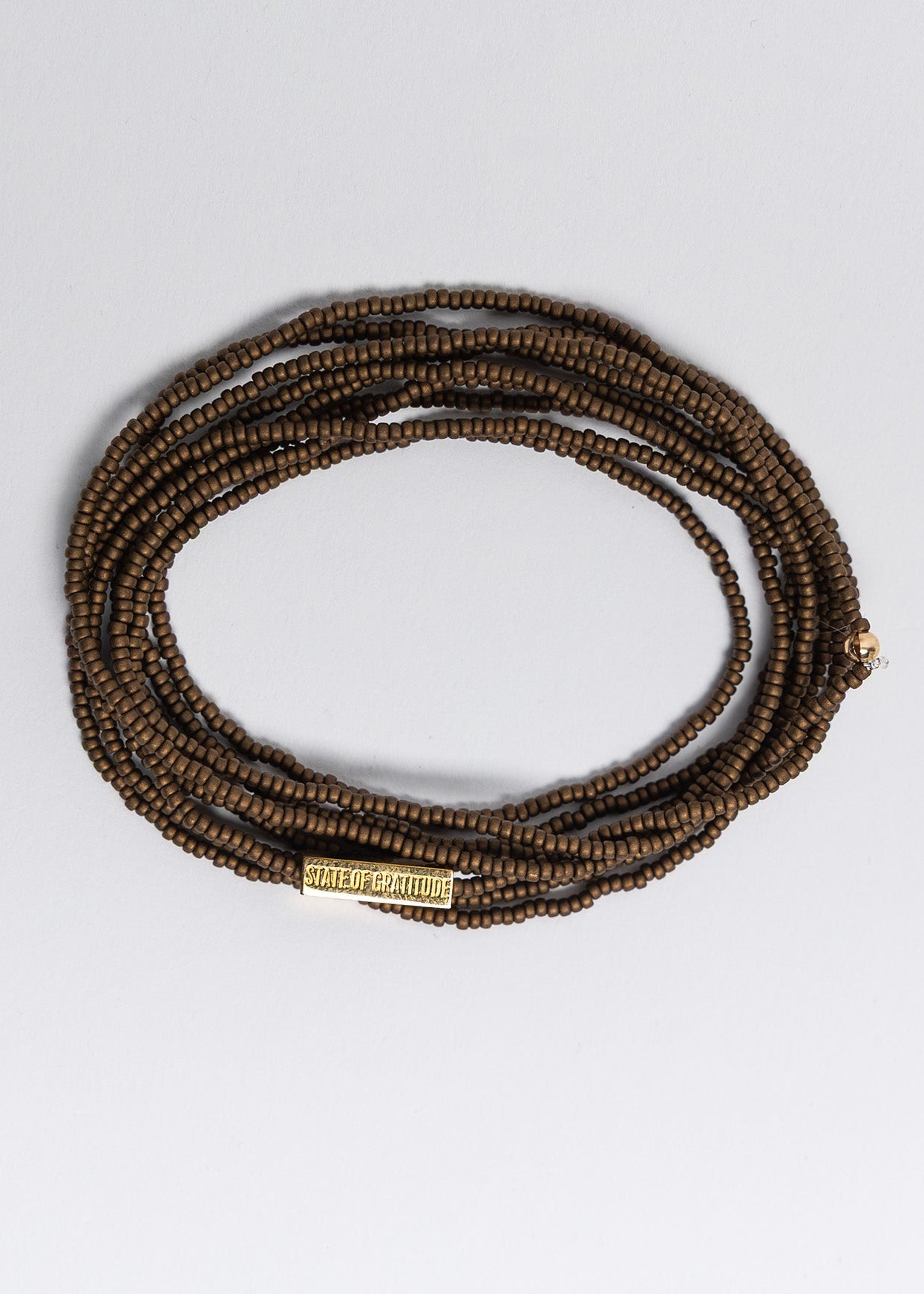 bronze beaded bracelet on a white background