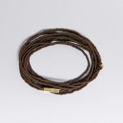bronze beaded bracelet on a white background