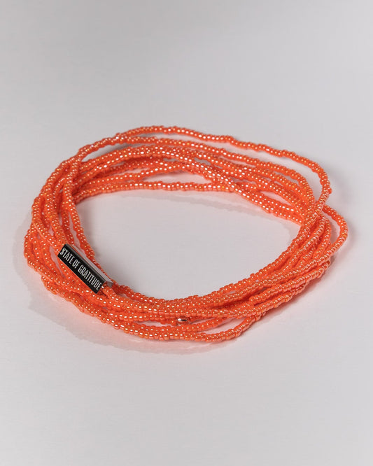 Orange braided cord with a label on a white background