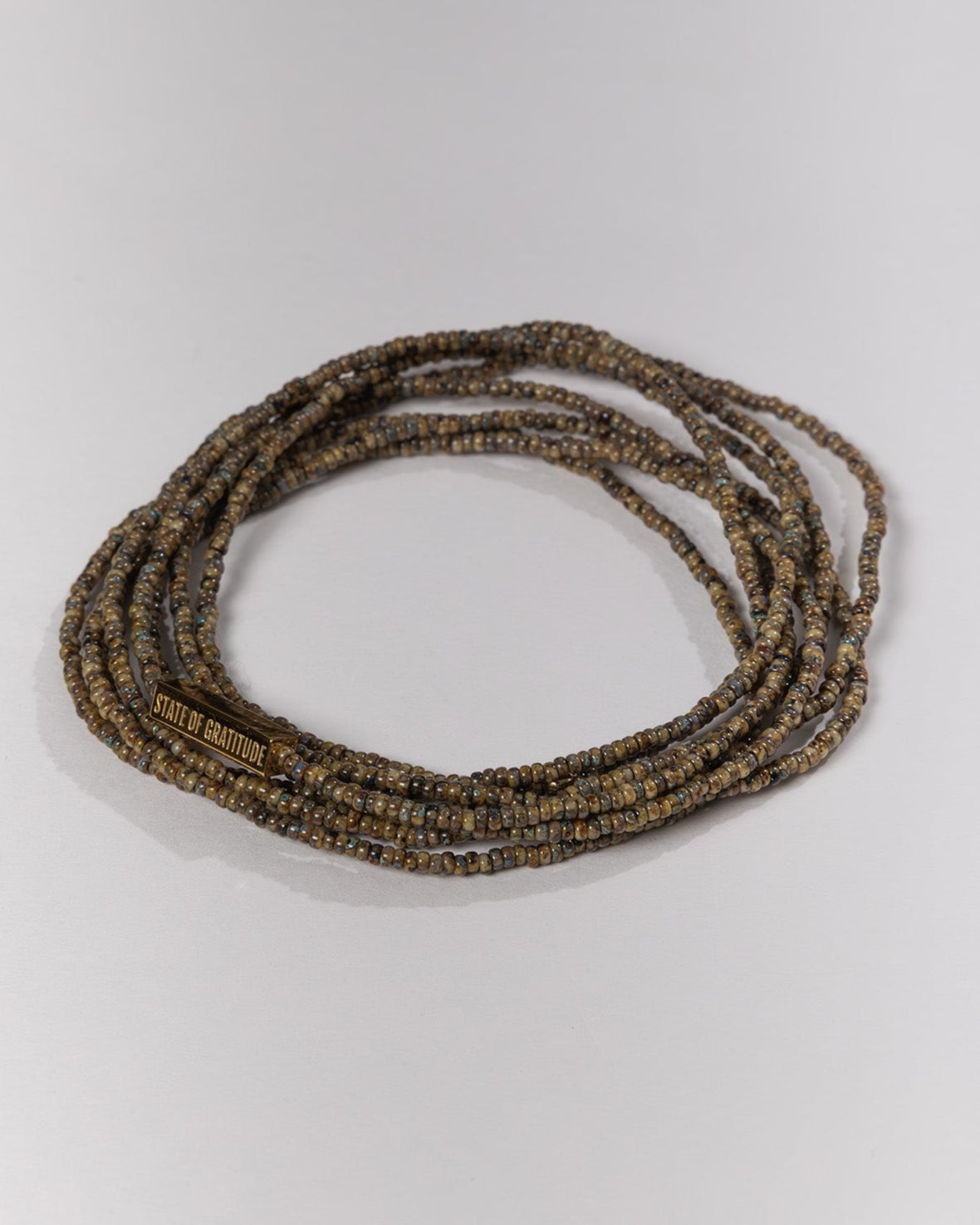 String of dark brown beads on a light gray background
