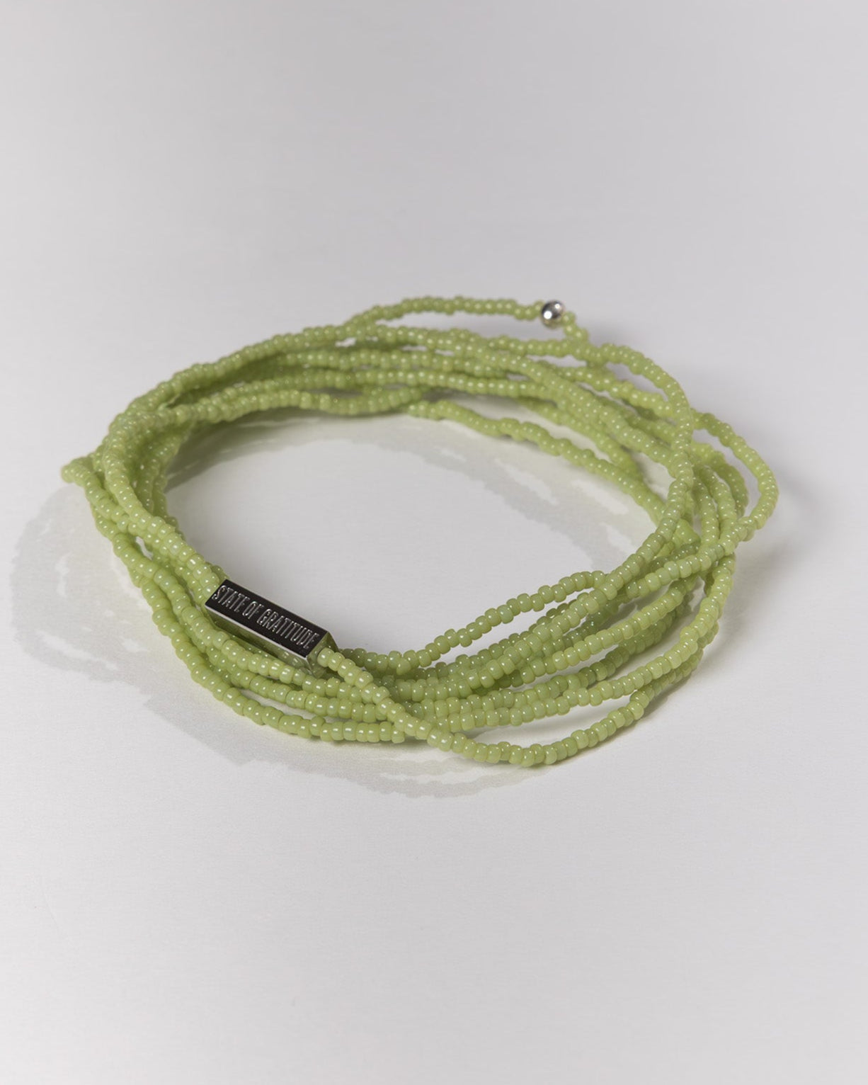 Green beaded bracelet on a white background