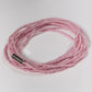 pink beaded bracelet on a white background