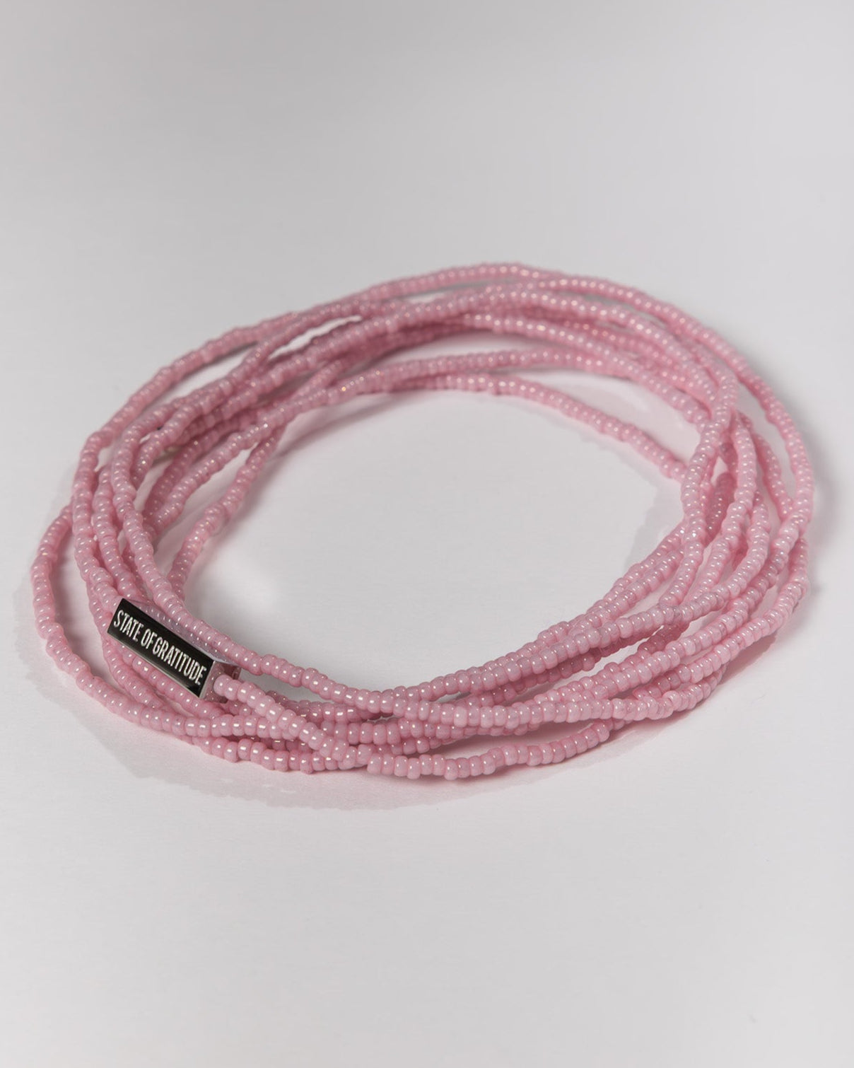 pink beaded bracelet on a white background