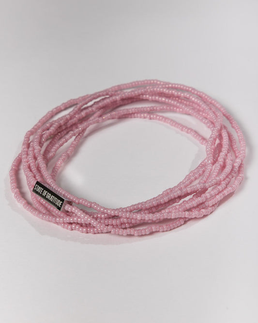 pink beaded bracelet on a white background