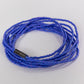 Blue beaded bracelet on a light gray background