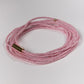 Pink beaded bracelet on a white background with gold link reading STATE OF GRATITUDE